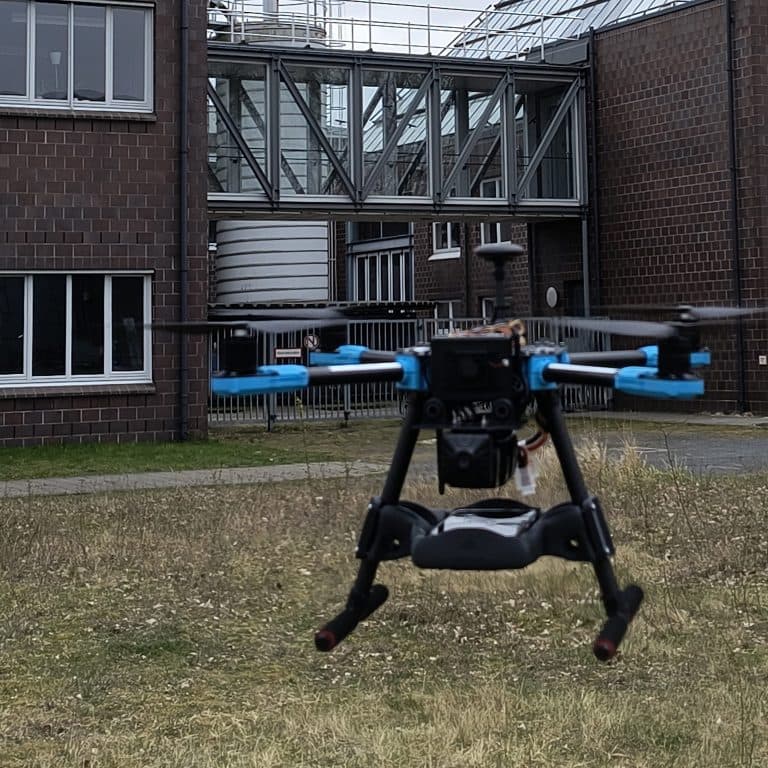 Drone hovering in front of industrial building